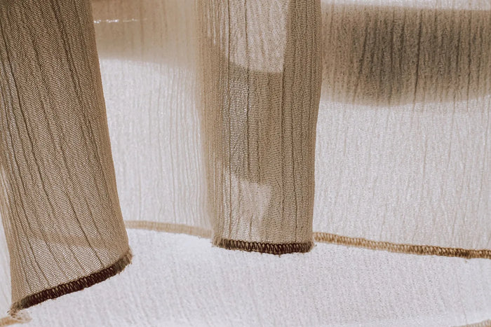 Warm sunlight across a neutral still life, sun-and-skin skincare mood.