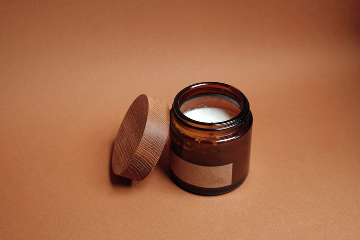 Balm jar on a wooden shelf in soft light, shelf-life storage still life.