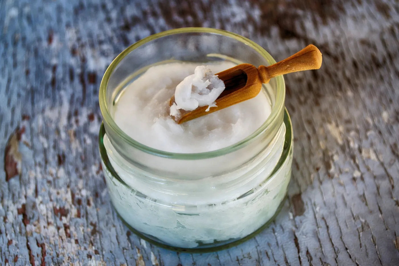 Coconut oil in a glass jar, soft neutral light, natural oils comparison.