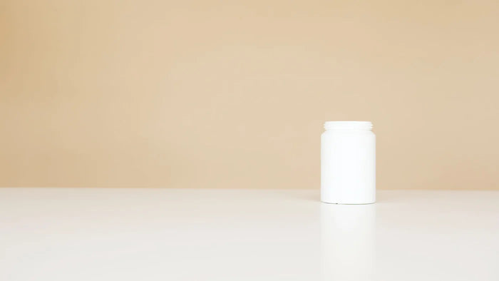 Plain unscented cosmetic jar with soft shadow, fragrance-free skincare still life.