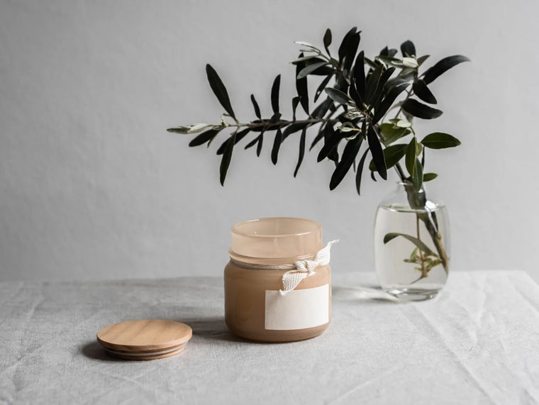 Open balm jar on linen in soft light, honey-free moisturizer still life.