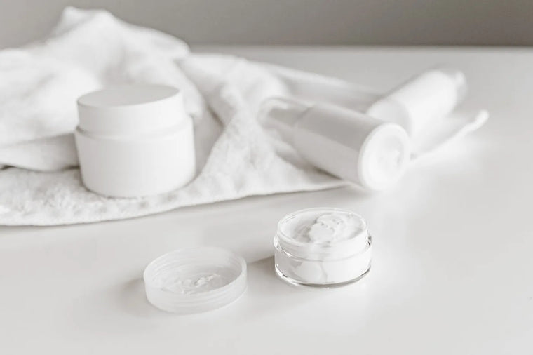 Plain white cosmetic jar with soft shadow, minimal fragrance-free skincare.