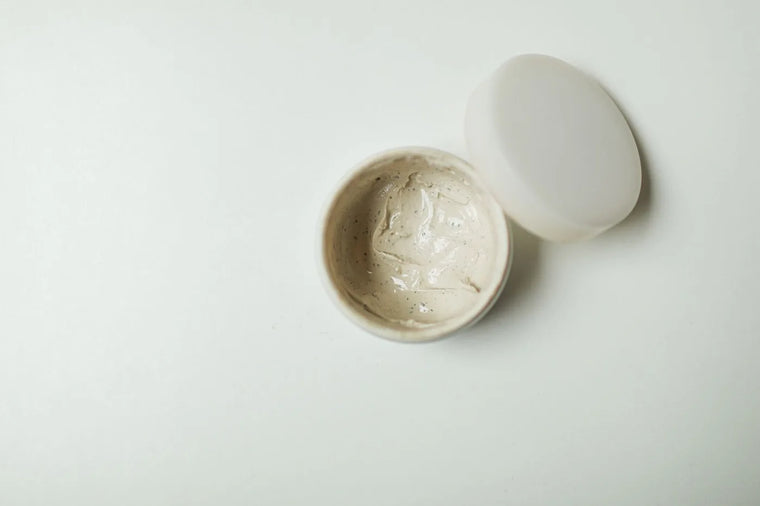 Clean minimal cosmetic jar in soft neutral light, clean-beauty still life.