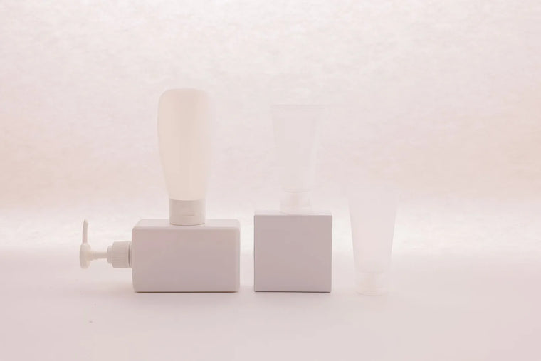 Unbranded blank-label skincare bottle in soft light, ingredient-label still life.