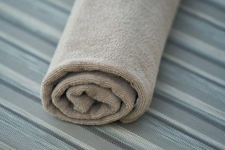 Soft muslin cloth in gentle neutral light, calm baby-skincare mood.