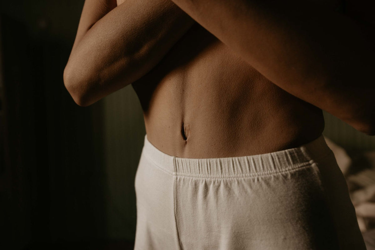 Warm sunlight across bare skin in neutral tones, after-sun mood.