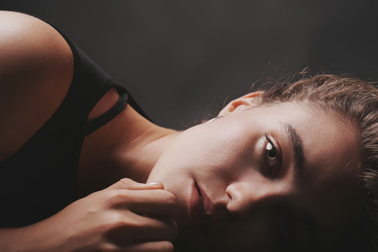 Close natural light on clear calm skin, neutral skincare mood.