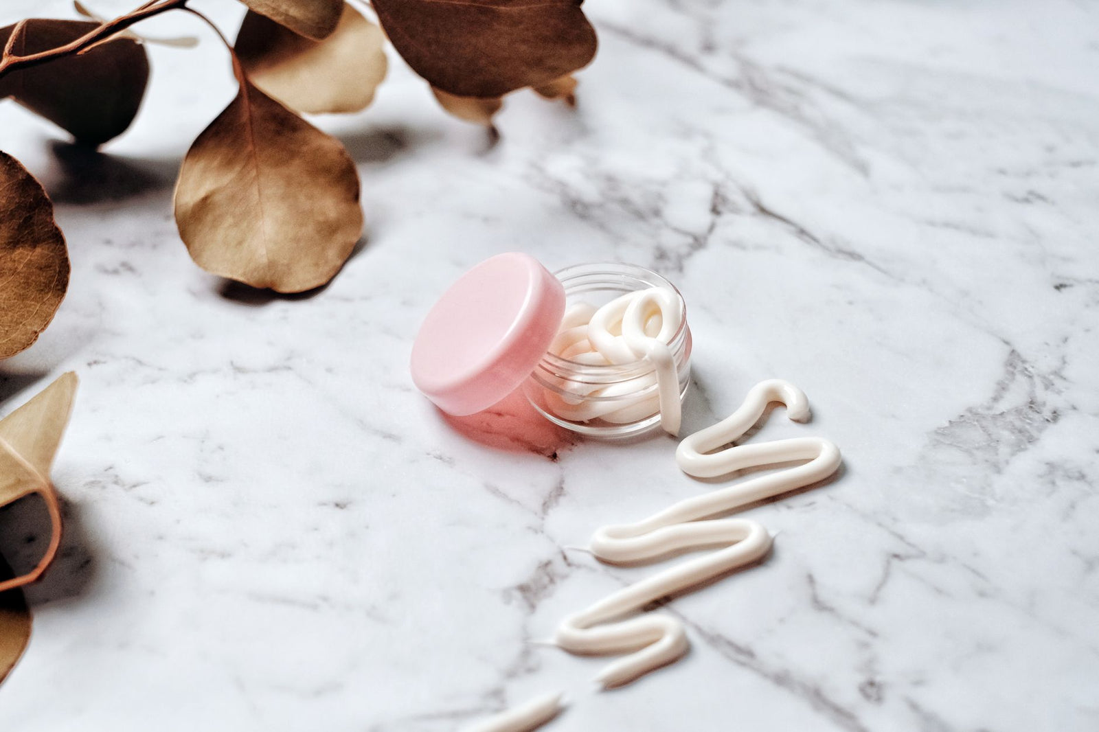Neutral skincare still life in soft light, gentle aftercare mood.