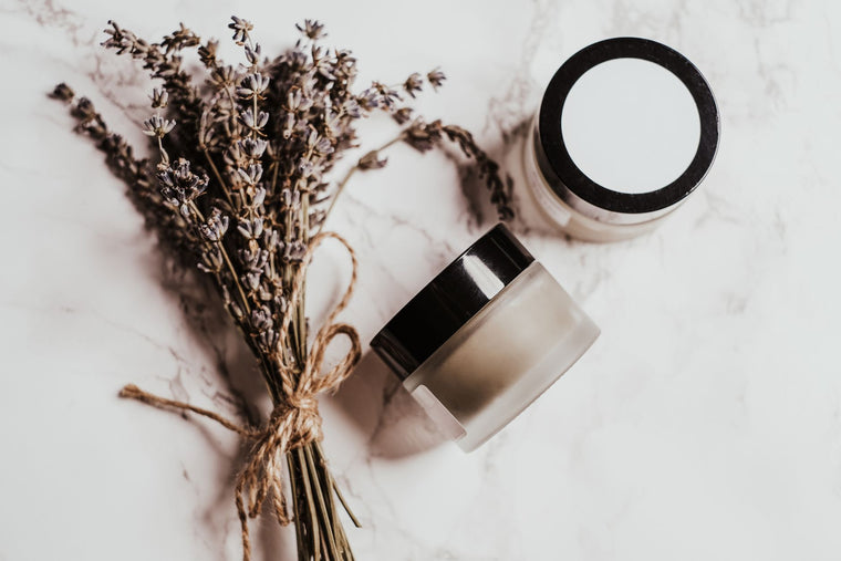 Balm jar on linen in soft natural light, application still life.