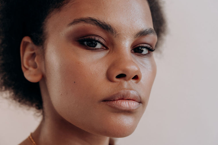 Soft light across the under-eye area, calm neutral portrait mood.
