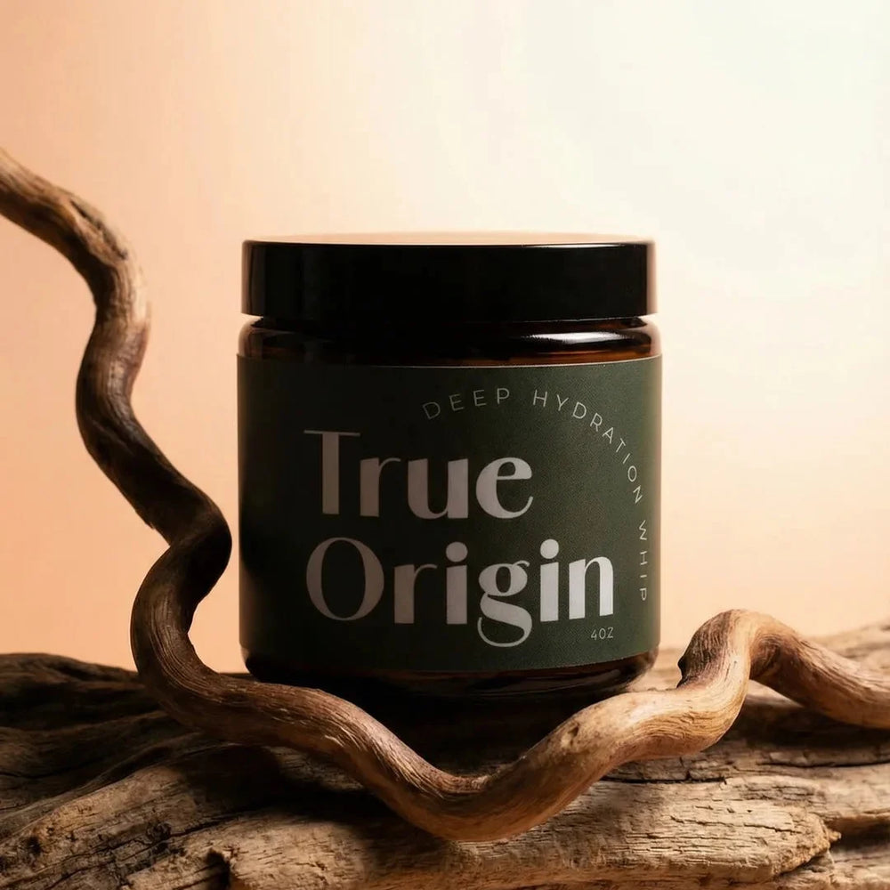 True Origin Deep Hydration Whip jar on driftwood